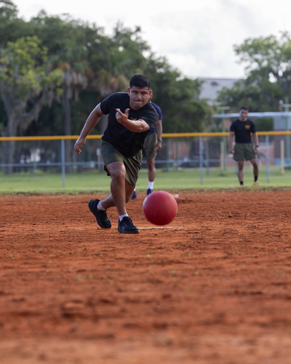 A player mid-kick, leg swinging through, on a sunny afternoon